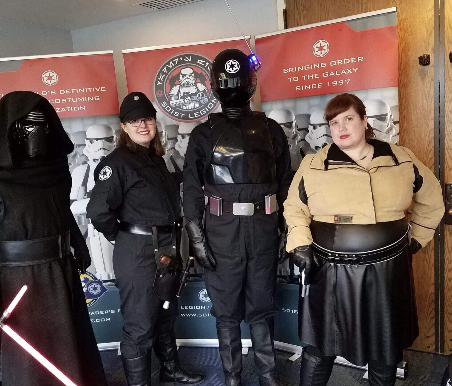 Costumed members posing with 501st Legion banners
